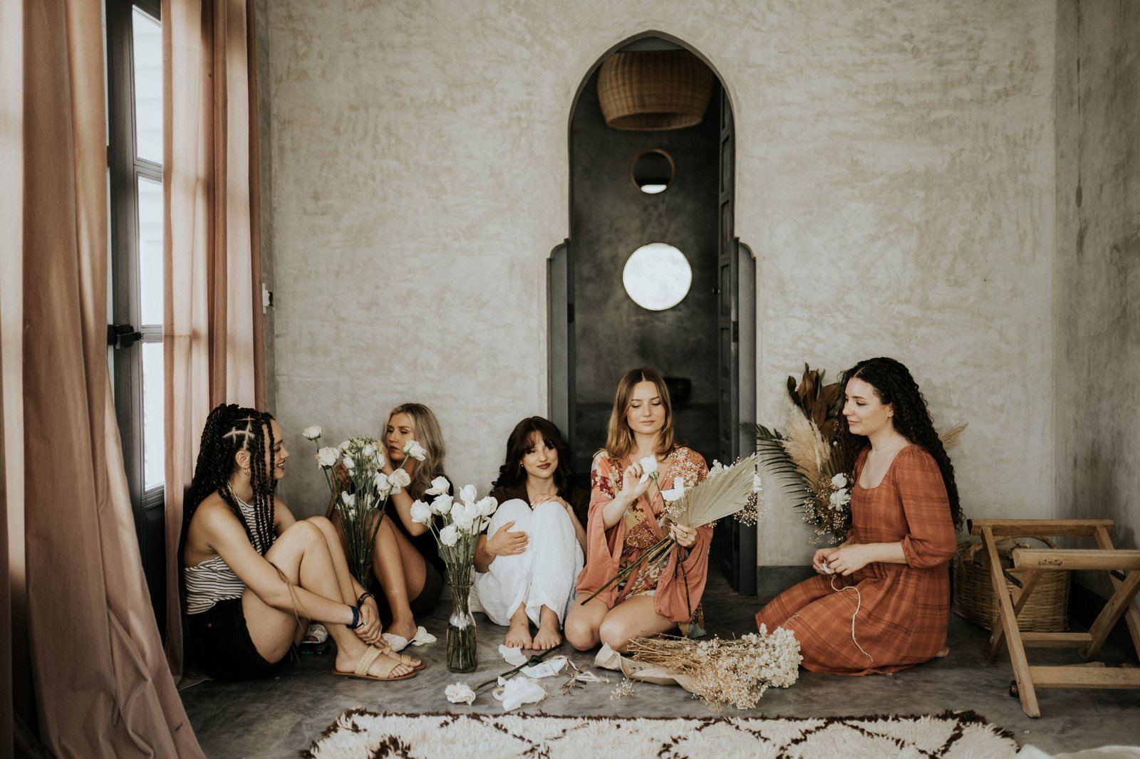 The group arranging the bouquets in the suite