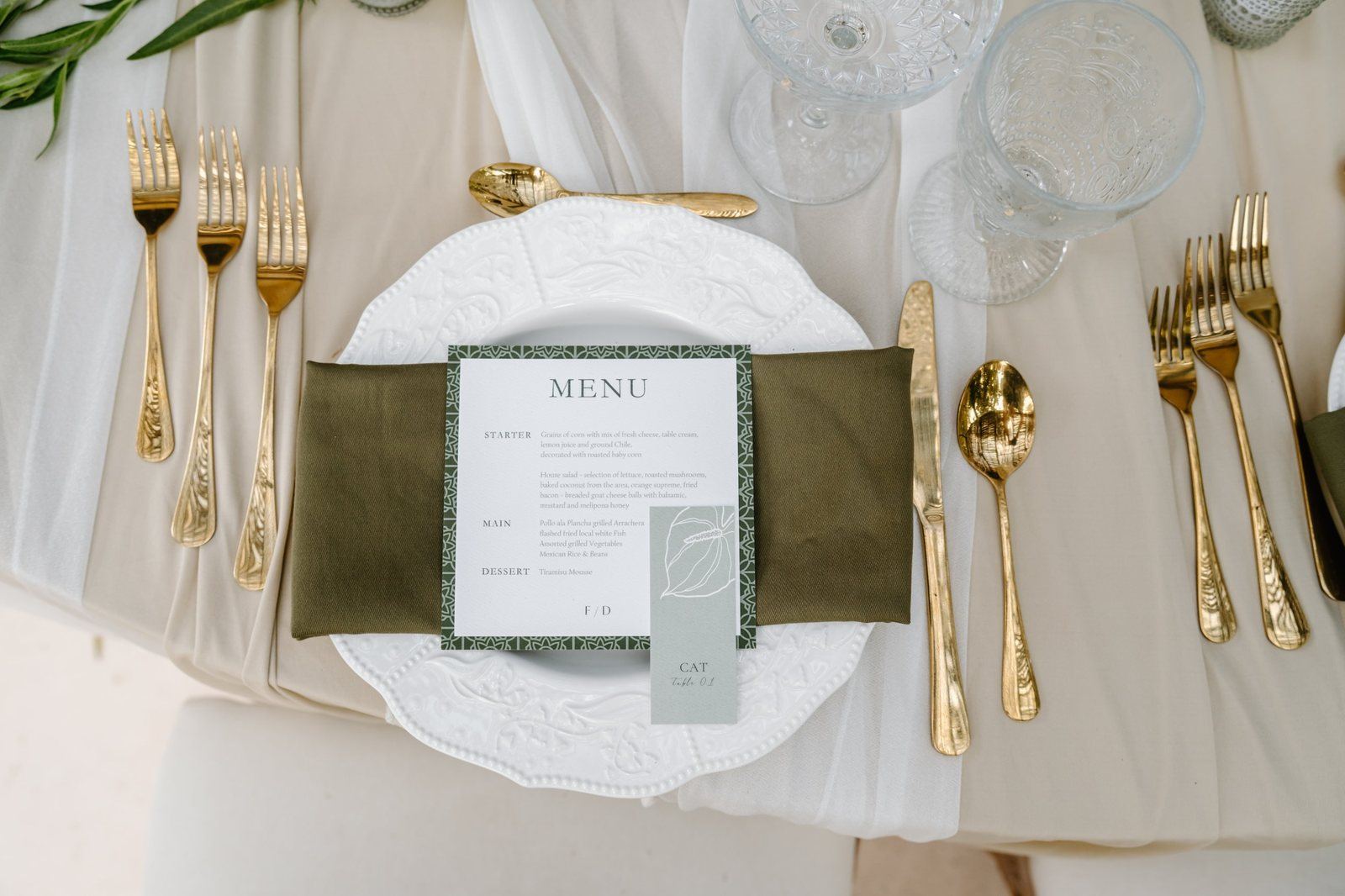 Printed menu on the plate, with gold cutlery